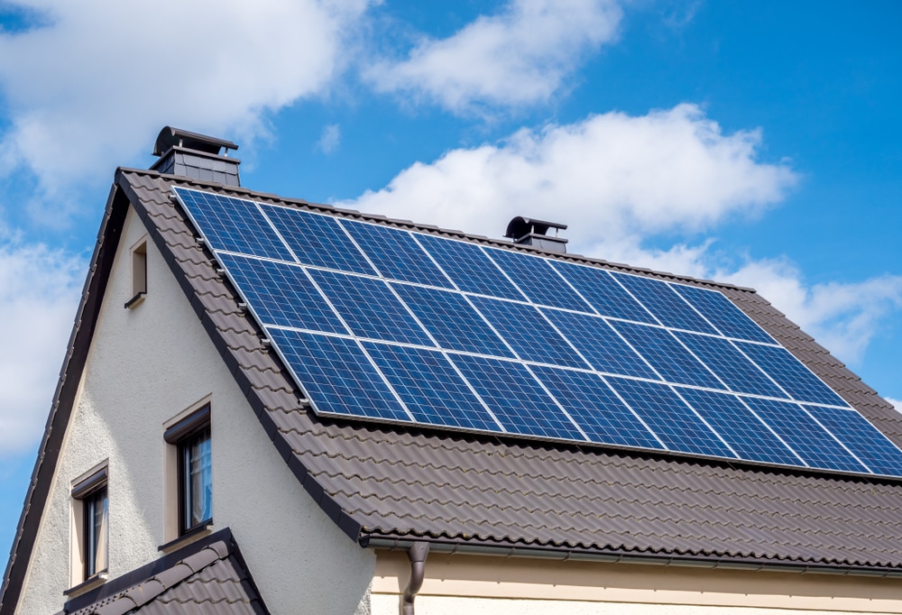 Solar panels on a roof with blue sky in the background